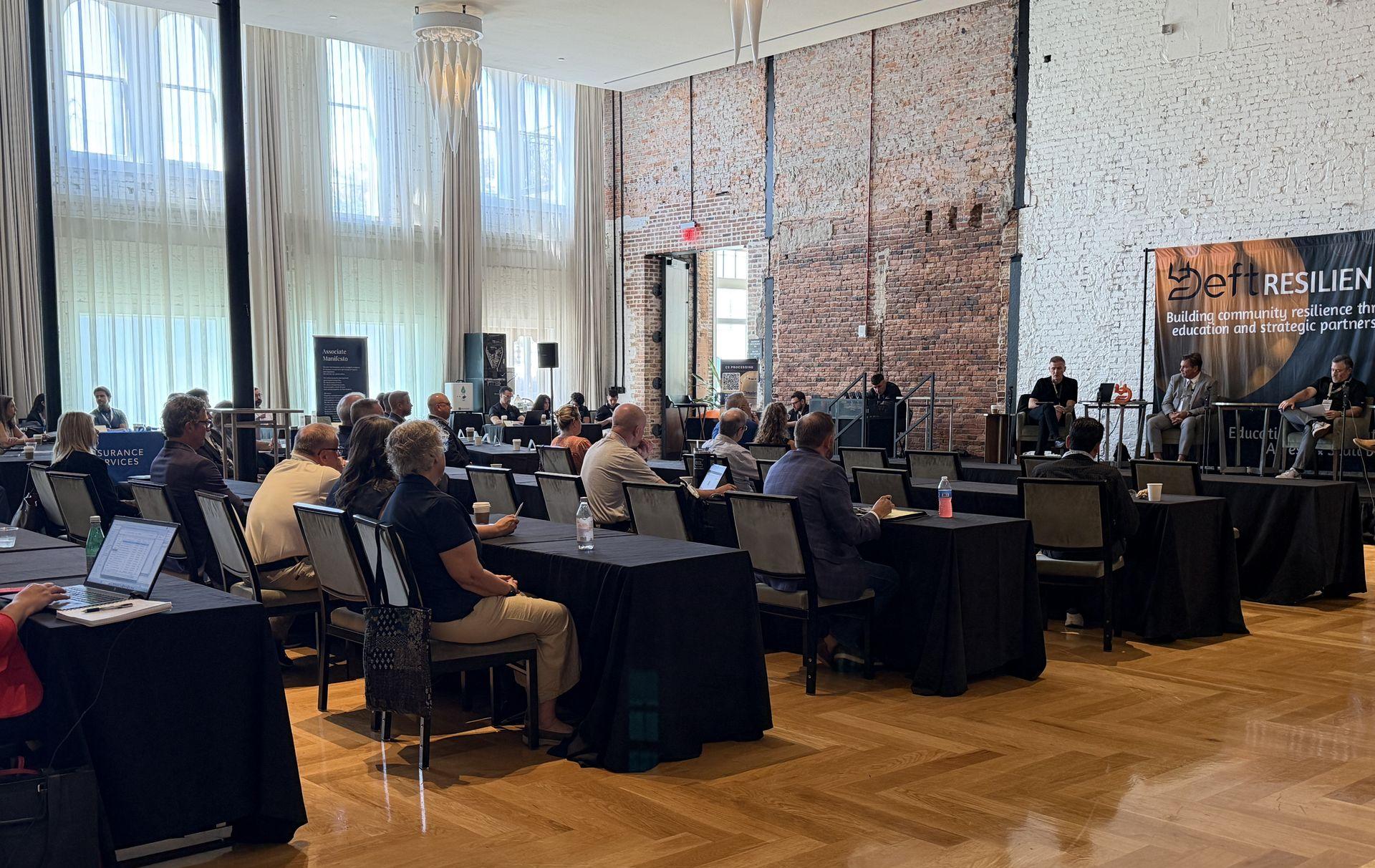 Attendees watching flood panel at Deft Resilience Tampa 2026